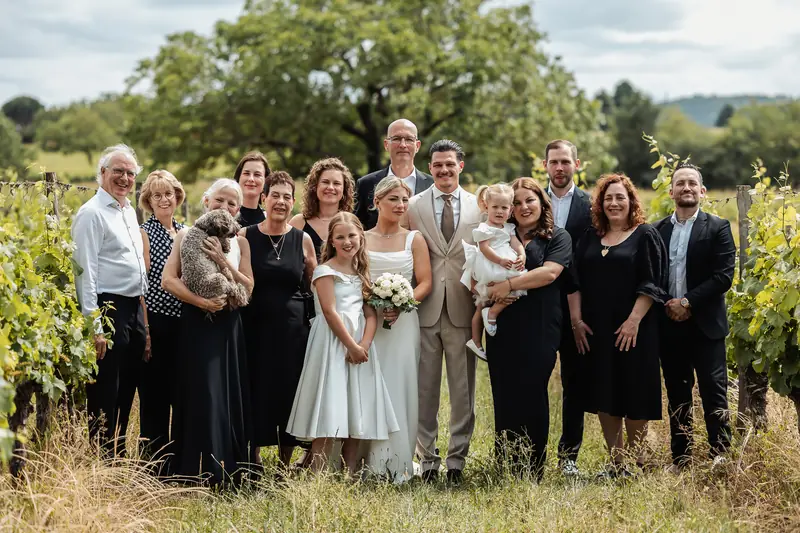 Familiefoto van het bruidspaar in een wijngaard